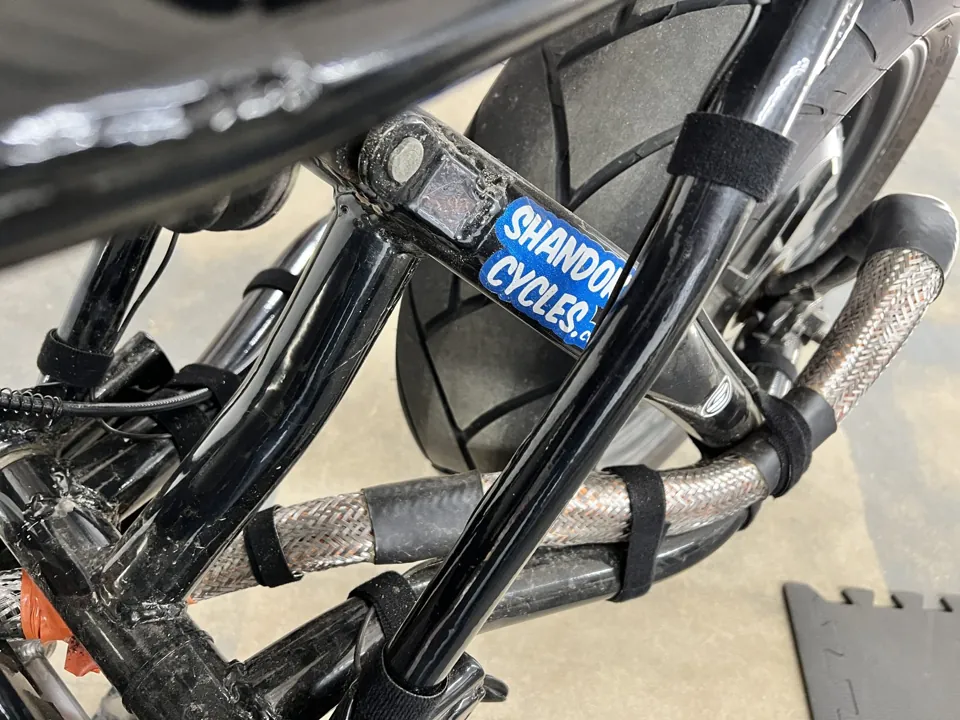 A swingarm with a Shandoka Cycles sticker in the Mars Hill shop